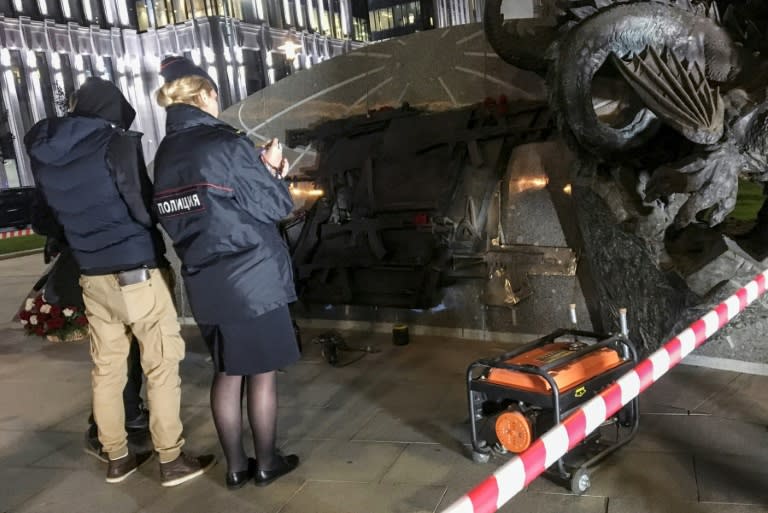 Police officers collect evidence after a section allegedly featuring German StG44 rifle was removed from the newly unveiled monument dedicated to Mikhail Kalashnikov, the inventor of the AK-47 assault rifle, in Moscow on September 22, 2017