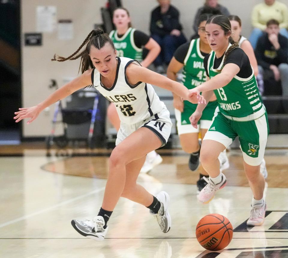 Noblesville High School's Reagan Wilson (22) defends a loose ball from Valparaiso High School's Brianna Fincannon (13) at Noblesville High School, Dec 28, 2023. Noblesville won 65-56.