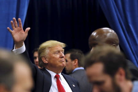 U.S. Republican presidential candidate Donald Trump waves to the crowd as he leaves a campaign rally at the University of Iowa in Iowa City, Iowa, January 26, 2016. REUTERS/Scott Morgan