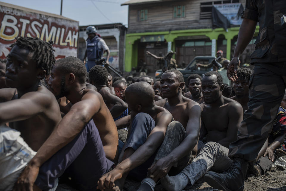 Arrested members of the Wazalendo sect are sat and lined up in Goma, Democratic Republic of the Congo, Wednesday, Aug. 30, 2023. More than 40 people died and dozens were injured in clashes in the Congolese city of Goma between protesters from the Wazalendo religious sect and the armed forces, national authorities said. (AP Photo/Moses Sawasawa)