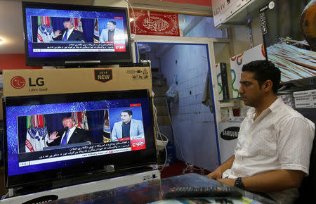 An Afghan man watches the TV broadcast of the U.S. President Donald Trump's speech, in Kabul, Afghanistan August 22, 2017. REUTERS/Omar Sobhani