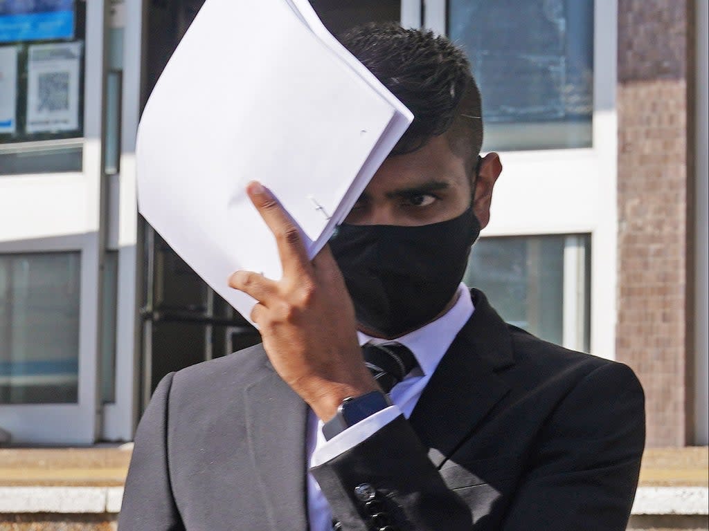 Javed Saumtally covers up as he leaves Hove Crown Court in August  (Yui Mok/PA)