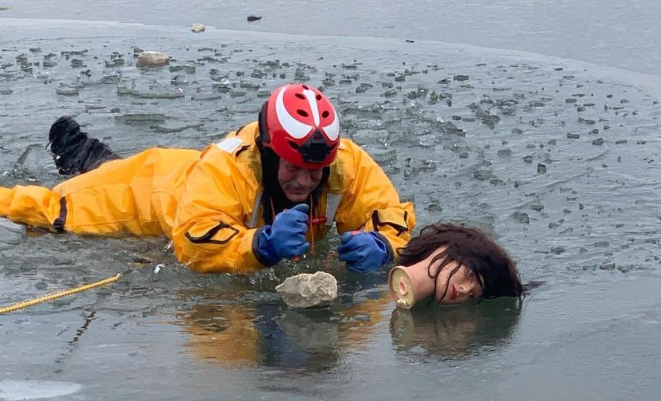 Wearing an ice suit, Monroe Fire Protection District firefighter Joey McWhorter Jr. makes his way to what turned out to be the head of a mannequin someone had tossed onto the ice at Lake Monroe.