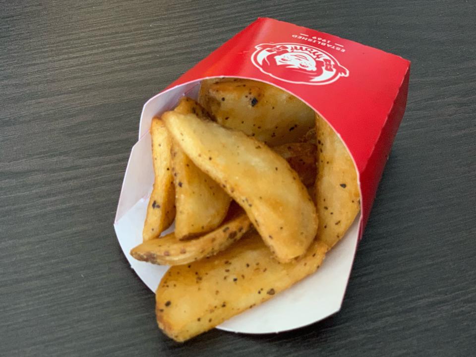 Wendy's breakfast potatoes in original packaging on wooden table