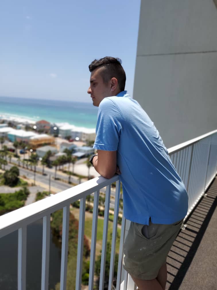 Emilio Rivamar stands on a balcony of a hotel he was painting in Panama City Beach, Florida, before he was laid off because of a downturn in bookings from the coronavirus pandemic.