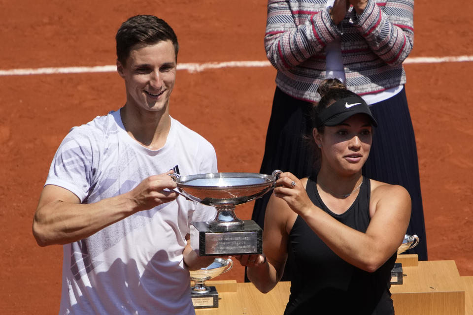 USA's Desirae Krawczyk, right, and Britain's Joe Salisbury hold the cup after defeating Russia's Elena Vesnina and Aslan Karatsev in their mixed doubles final match of the French Open tennis tournament at the Roland Garros stadium Thursday, June 10, 2021 in Paris. (AP Photo/Christophe Ena)