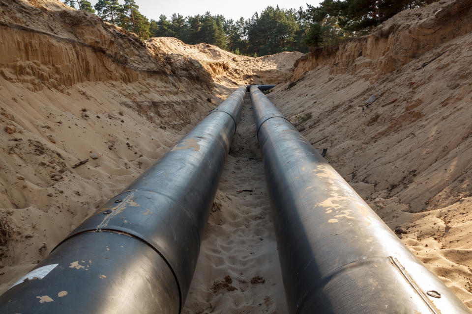 An uncovered pipeline construction site with sand around it.