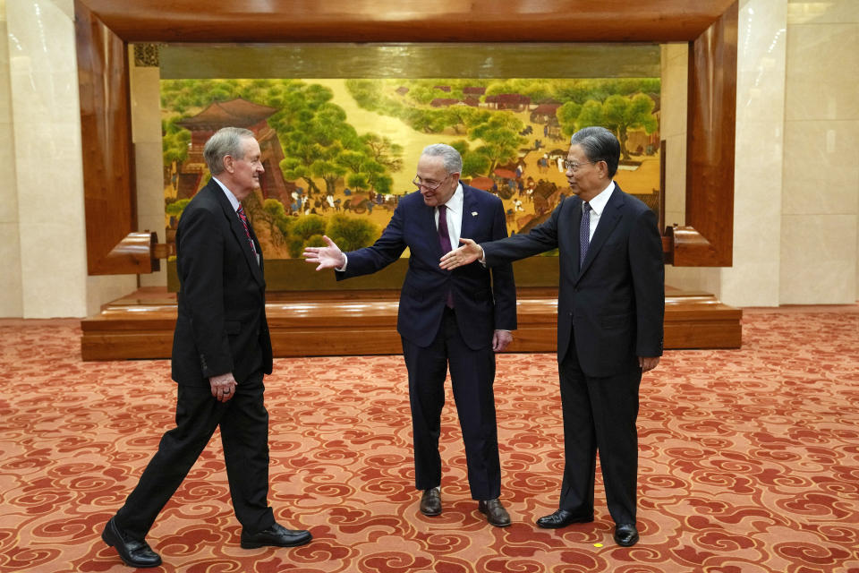 Visiting U.S. Senate Majority Leader Chuck Schumer, D-N.Y., center, introduces U.S. Sen. Mike Crapo, R-Idaho, left, to Zhao Leji, right, chairman of China's National People's Congress, before their bilateral meeting at the Great Hall of the People in Beijing, Monday, Oct. 9, 2023. (AP Photo/Andy Wong, Pool)