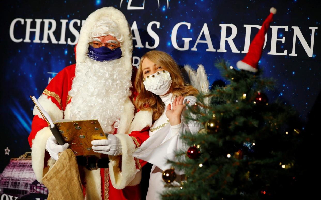 Masked santas could become a feature of Christmas this year -  FABRIZIO BENSCH/Reuters