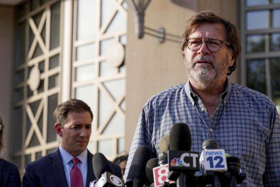 Bill Sherlach, husband of Mary, one of the Sandy Hook School shooting victims, speaks to the media after jurors returned a $965 million dollar judgement in the defamation trial against Alex Jones, in Waterbury, Conn, Wednesday, Oct. 12, 2022. (AP Photo/Bryan Woolston)