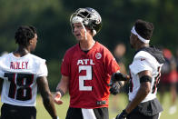 Atlanta Falcons quarterback Matt Ryan (2) talks to receivers Calvin Ridley (18) and Russell Gage (14) during the team's NFL training camp football practice in Flowery Branch, Ga. Thursday, July 29, 2021. (AP Photo/ John Bazemore)