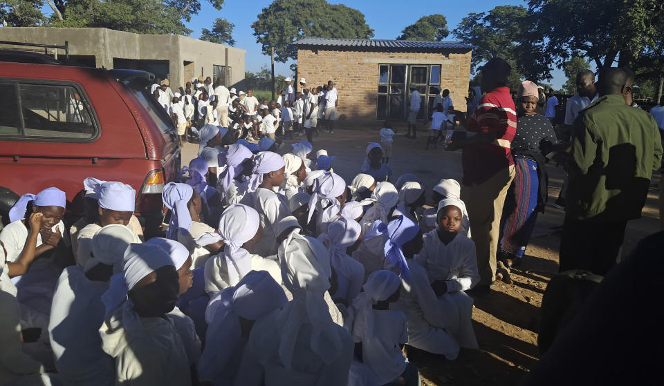 Children are rounded up at a shrine on a farm about 34 kilometers (21 miles) north of the capital, Harare, Wednesday, March, 13, 2024. Zimbabwean police on Wednesday said they arrested a man claiming to be a prophet of an apostolic sect at a shrine where believers stay in a compound and authorities found 16 unregistered graves, including those of infants, and more than 250 children used as cheap labor. (AP Photo)