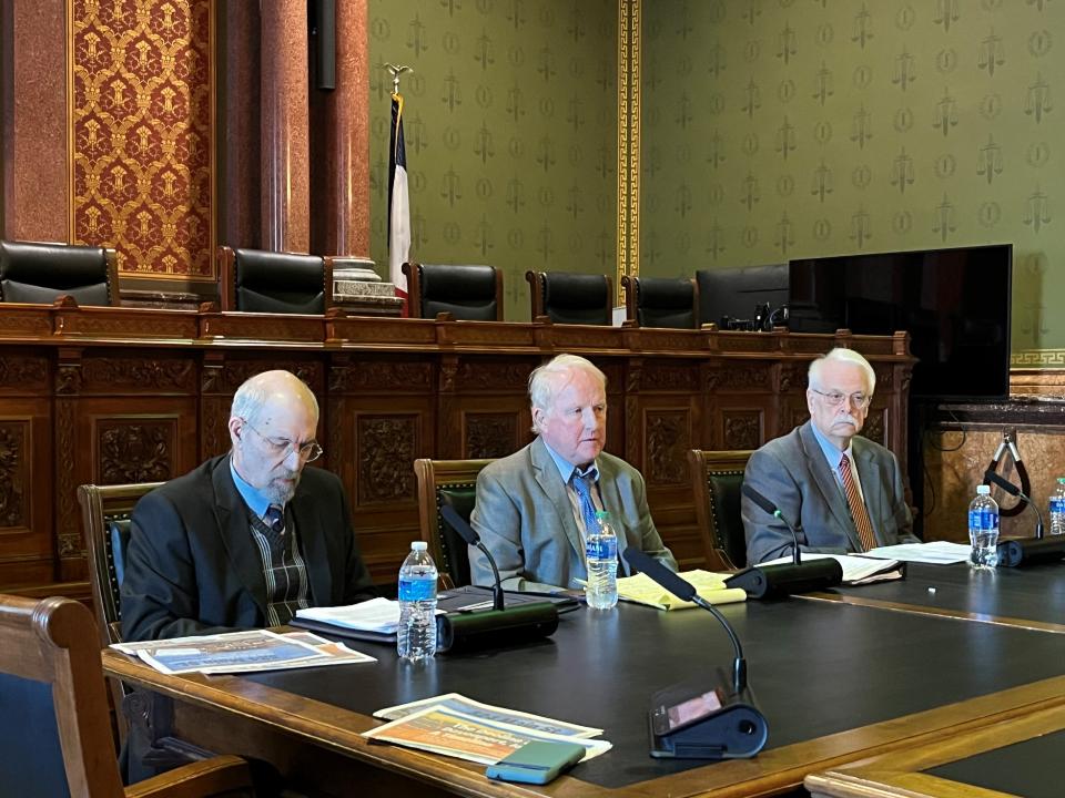 Attorney Mike Meloy, center, testifies at an Iowa House Government Oversight hearing on Wednesday, March 27, 2024, as David Sidran, left, and Randy Evans, right, look on.