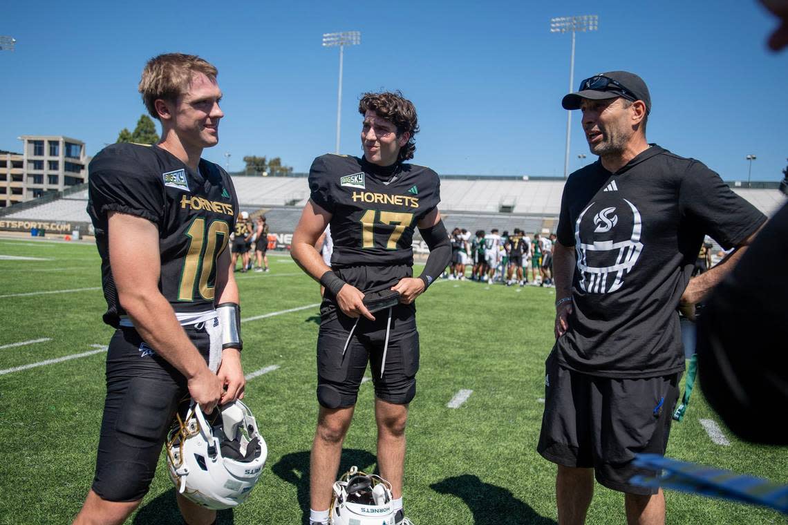 Sacramento State Hornets quarterbacks Joey Cook (10) and Carson Conklin (17) talk with quarterback coach Bobby Fresques after the annual Sacramento State spring football game on Saturday at Sacramento State.