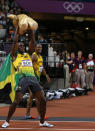 Jamaica's Usain Bolt holds a 'Wenlock' London 2012 Olympics mascot after he won the men's 100m final during the London 2012 Olympic Games at the Olympic Stadium August 5, 2012. Bolt set an Olympic record with a time of 9.63 seconds. REUTERS/Phil Noble (BRITAIN - Tags: OLYMPICS SPORT ATHLETICS) 