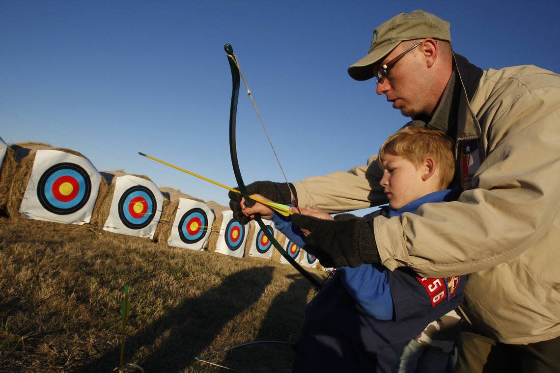 Nov. 15, 2008: Scott Broder, 7, of Cub Scout Troop 456 of Colleyville, gets help on the archery range from David Dawson, district executive of the Longhorn Council, at the Council Camporee at Texas Motor Speedway RICHARD W. RODRIGUEZ/SPECIAL TO THE STAR-TELEGRAM