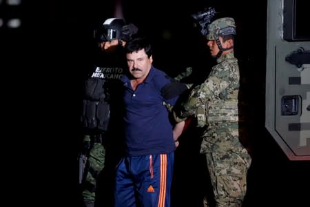 FILE PHOTO: Joaquin "El Chapo" Guzman is escorted by soldiers during a presentation in Mexico City