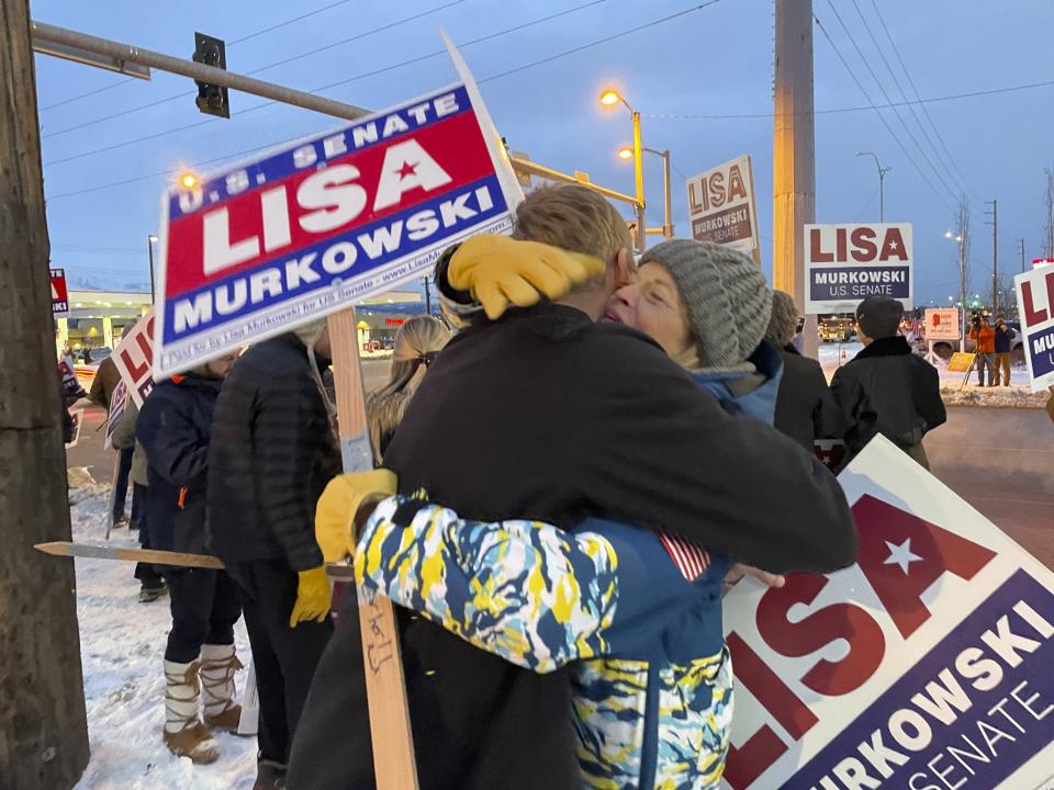 United States Sen. Lisa Murkowski, right, a Republican seeking reelection in Alaska, hugs her nephew, Luke Murkowski who flew in from Nome, Alaska, to surprise her at a sign-waving event on a busy Anchorage, Alaska, corner on Election Day, Tuesday, Nov. 8, 2022. Lisa Murkowski faces Republican Kelly Tshibaka and Democrat Pat Chesbro in the general election. (AP Photo/Mark Thiessen)