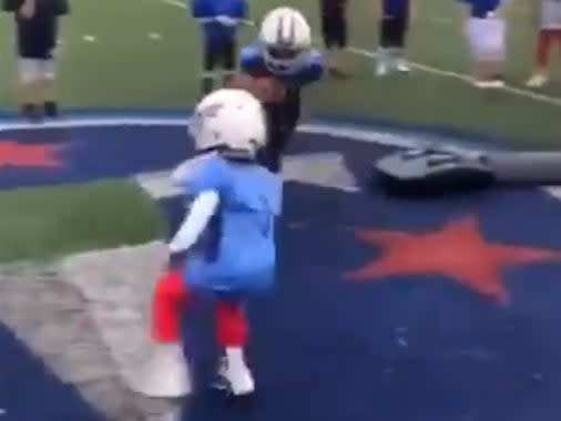 <p>Two small athletes can be seen ahead of a drill and then running directly at each other with helmets on</p> (Twitter)