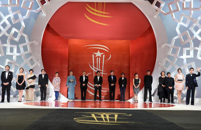 The Japanese delegation stands on stage during a tribute to Japanese Cinema at the 14th Marrakesh International Film Festival on December 9, 2014 in Marrakech