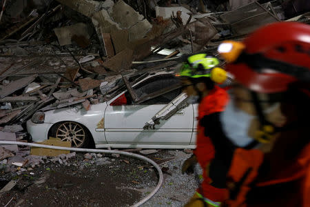 Rescue personnel search a collapses building after an earthquake hit Hualien, Taiwan February 7, 2018. REUTERS/Tyrone Siu