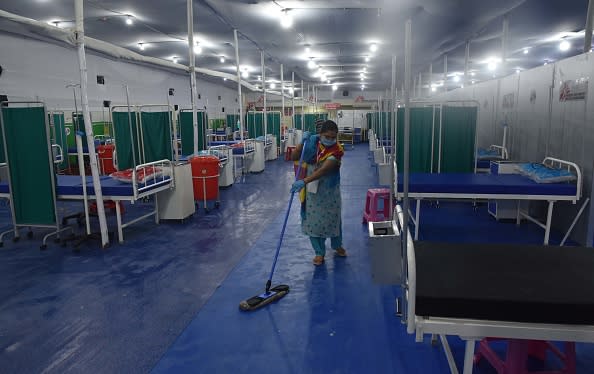 Cleaning staff at work at a temporary hospital with facilities for treatment of Covid-19 patients, at Patliputra Sports Complex in Patna, India.