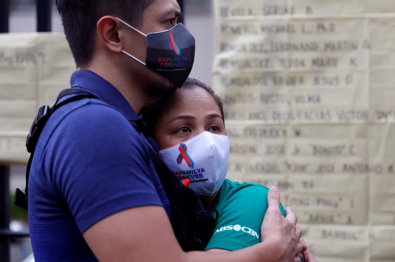 ABS-CBN employees react after the Philippine congress voted against the renewal of the broadcast network's 25-year franchise, outside ABS-CBN headquarters, in Quezon City