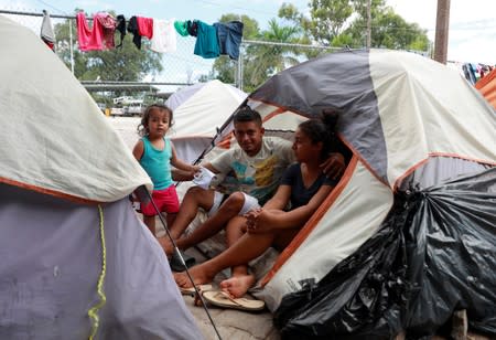 Honduran migrants Marvin Madrid and his new wife Dexy Maldonado speak during an interview with Reuters in an encampment in Matamoros