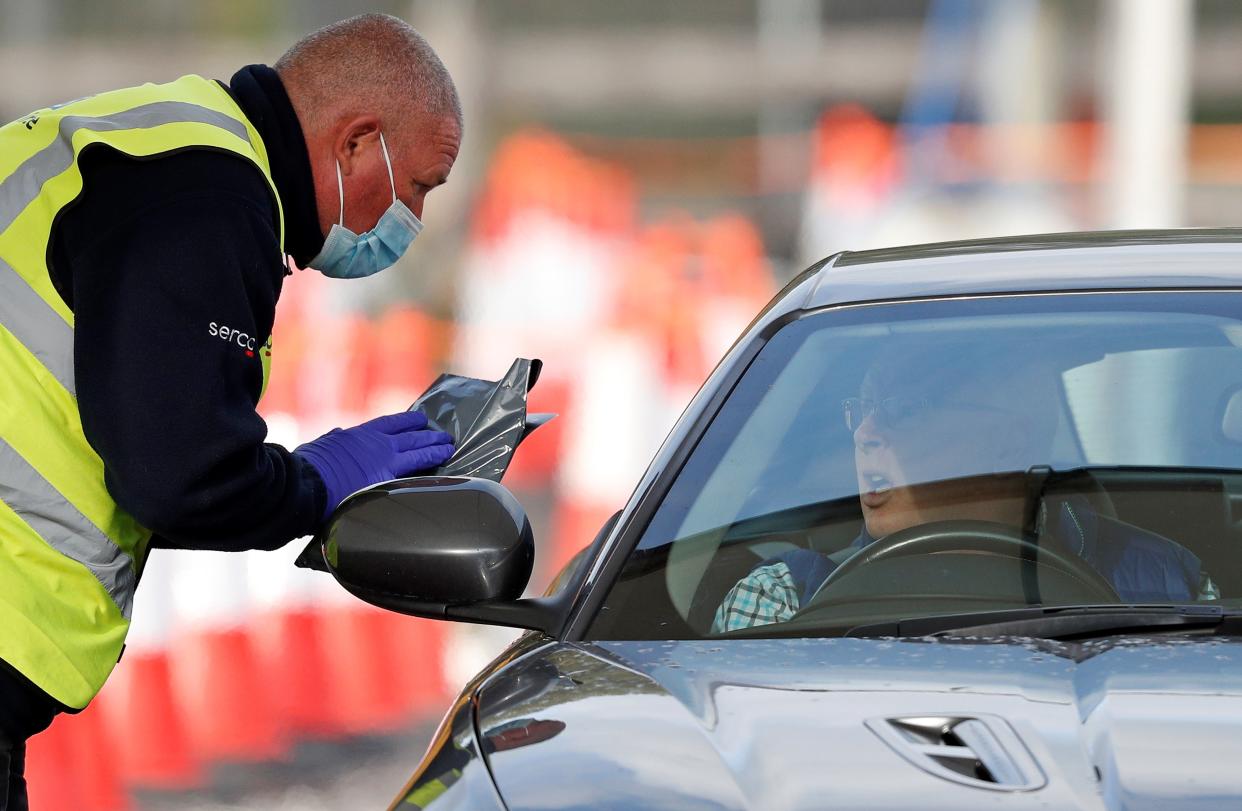 Serco workers help test people at a drive-in test site (AFP via Getty Images)