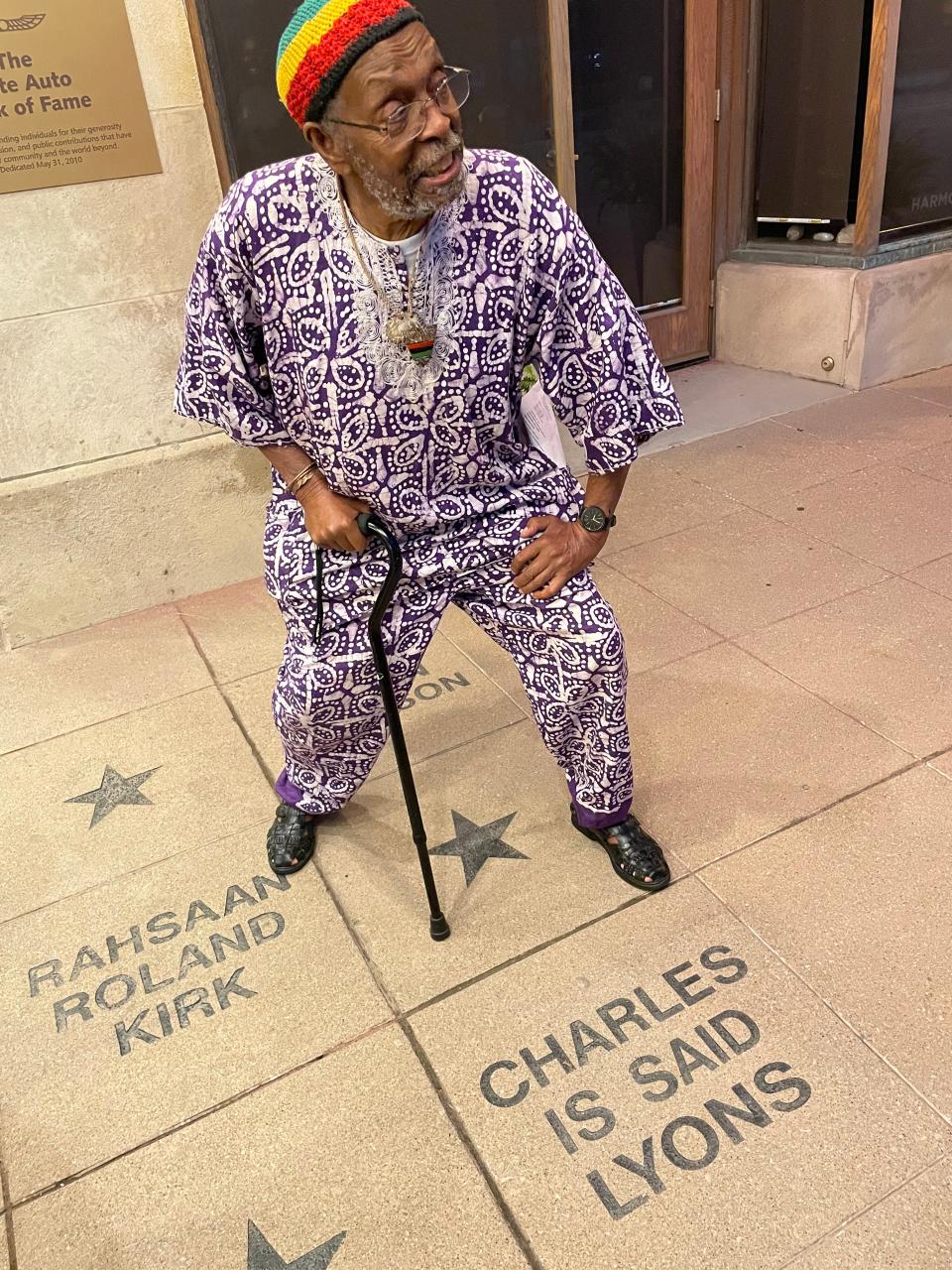 Charles "Is Said" Lyons poses by his name outside of the Lincoln Theatre, where he was inducted into the "Walk of Fame."