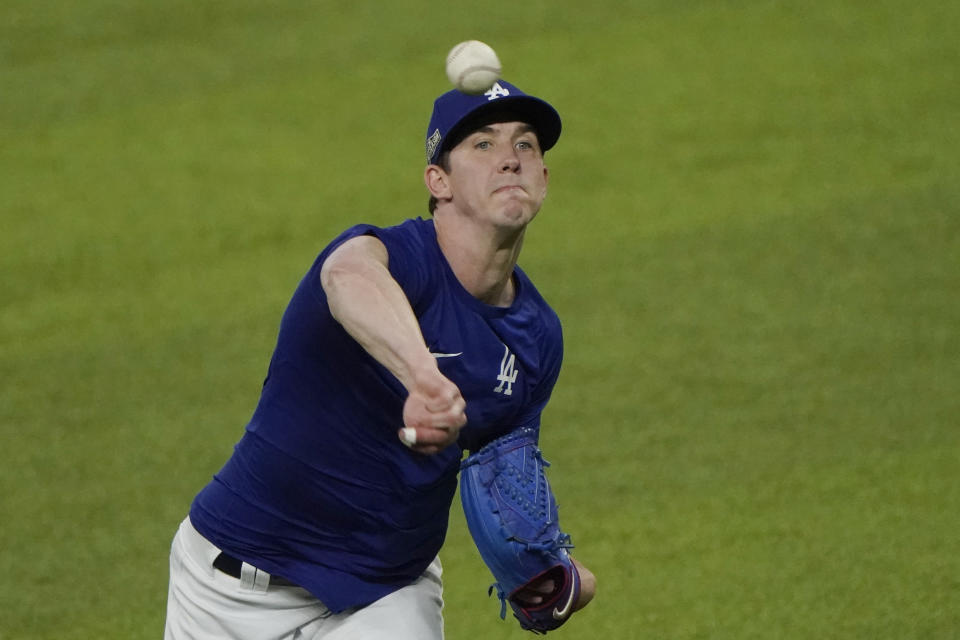 Los Angeles Dodgers' Walker Buehler, scheduled to pitch during Game 1 of the National League Championship Series against the Atlanta Braves, has tape on his fingers as he throws during a workout in Arlington, Texas, Sunday, Oct 11, 2020. The series begins Monday, Oct. 12. (AP Photo/Sue Ogrocki)