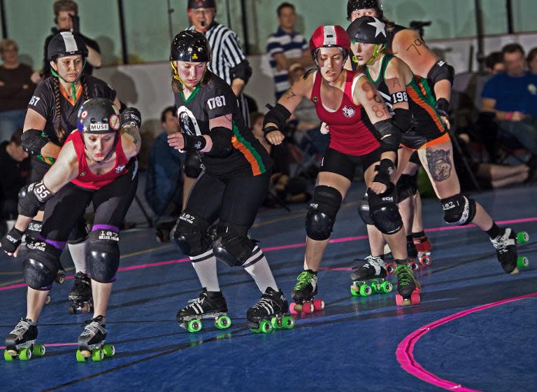 Rocktown Rollers' (in black) and DC Rollergirls battle it out on April 5, 2014 during the womens's flat track Roller Derby at the Dulles Sportsplex in Sterling, Virginia