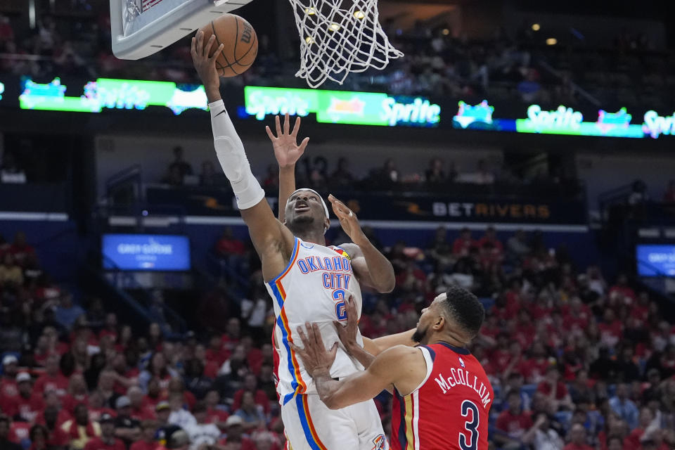 Oklahoma City Thunder guard Shai Gilgeous-Alexander (2) goes to the basket against New Orleans Pelicans guard CJ McCollum (3) in the second half of Game 3 of an NBA basketball first-round playoff series in New Orleans, Saturday, April 27, 2024. The Thunder won 106-85. (AP Photo/Gerald Herbert)