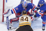 Boston Bruins center Jakub Lauko (94) is unable to score as New York Rangers goaltender Jonathan Quick (32) deflects the puck while Rangers center Alex Wennberg (91) defends in the second period of an NHL hockey game, Thursday, March 21, 2024, in Boston. (AP Photo/Steven Senne)