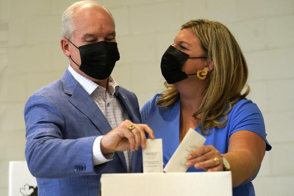 Conservative Leader Erin O'Toole and his wife Rebecca O'Toole cast their ballots for the Canadian general federal election in Bowmanville, Ont. on Monday, Sept. 20, 2021. (Adrian Wyld/The Canadian Press via AP)