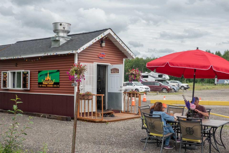 Bangkok Thai small restaurant with one chair and umbrella outside in Alaska