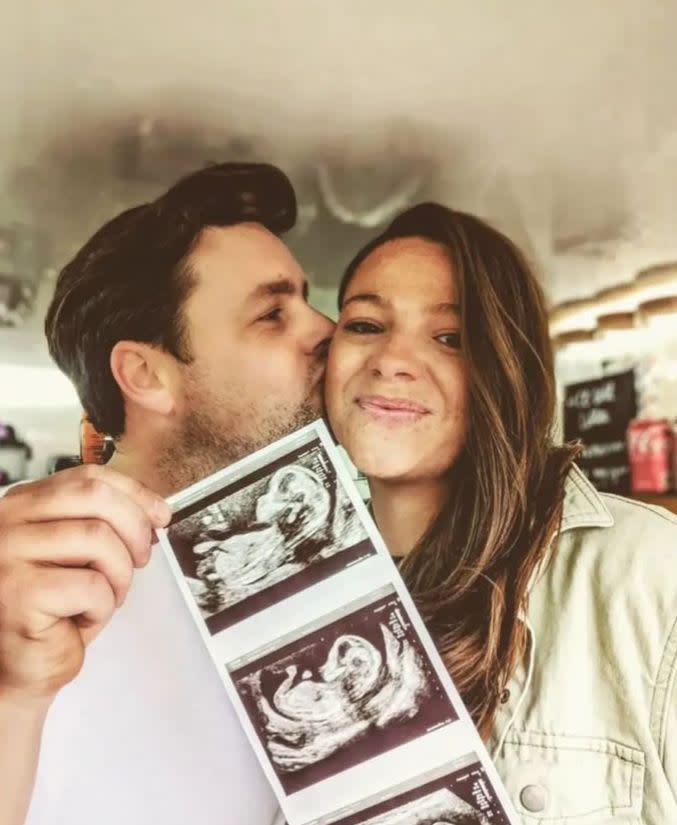 A couple holding a baby scan