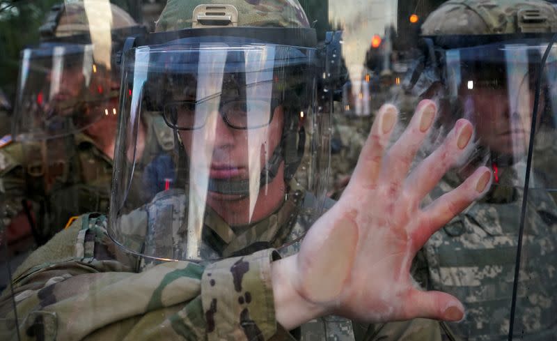 Soldier holds his position during a protest in Washington