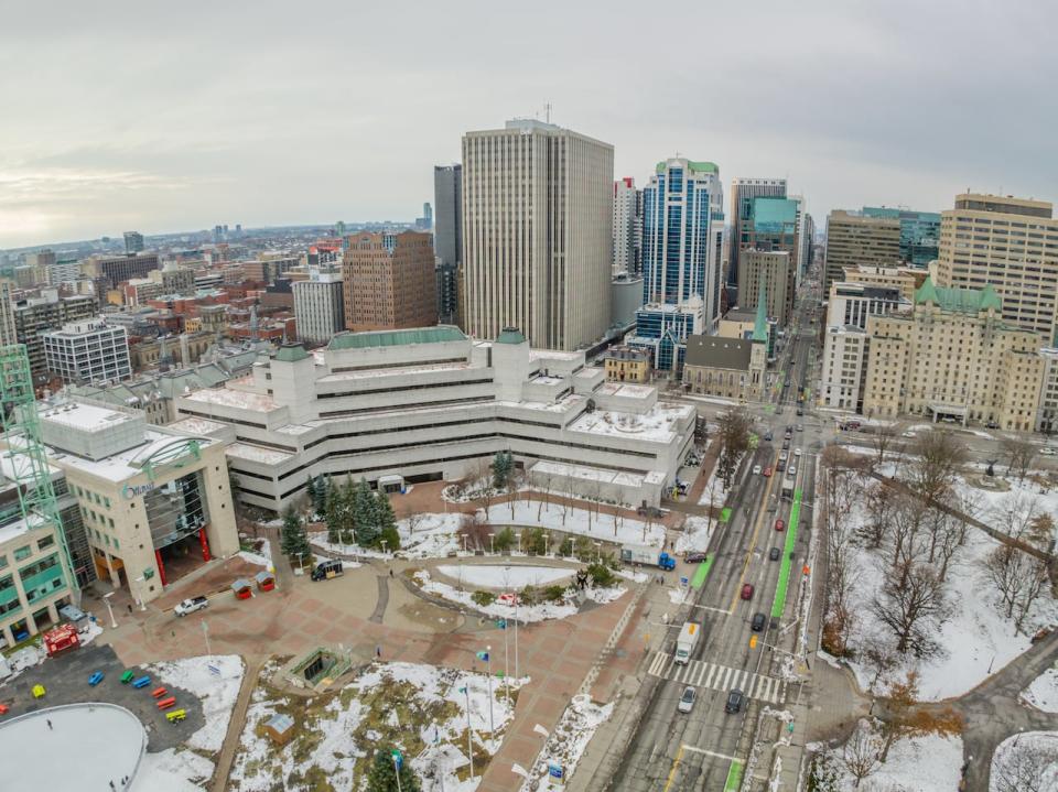 A drone photo of the Laurier Avenue side of Ottawa City Hall on Dec. 12, 2023, with the Ottawa Courthouse beside it and downtown Ottawa in the background.