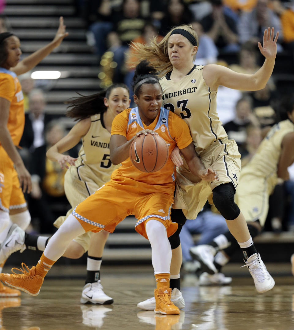 Tennessee guard Ariel Massengale, center, dribbles against Vanderbilt guard Kylee Smith (23) in the first half of an NCAA college basketball game on Sunday, Jan. 12, 2014, in Nashville, Tenn. (AP Photo/Mark Humphrey)