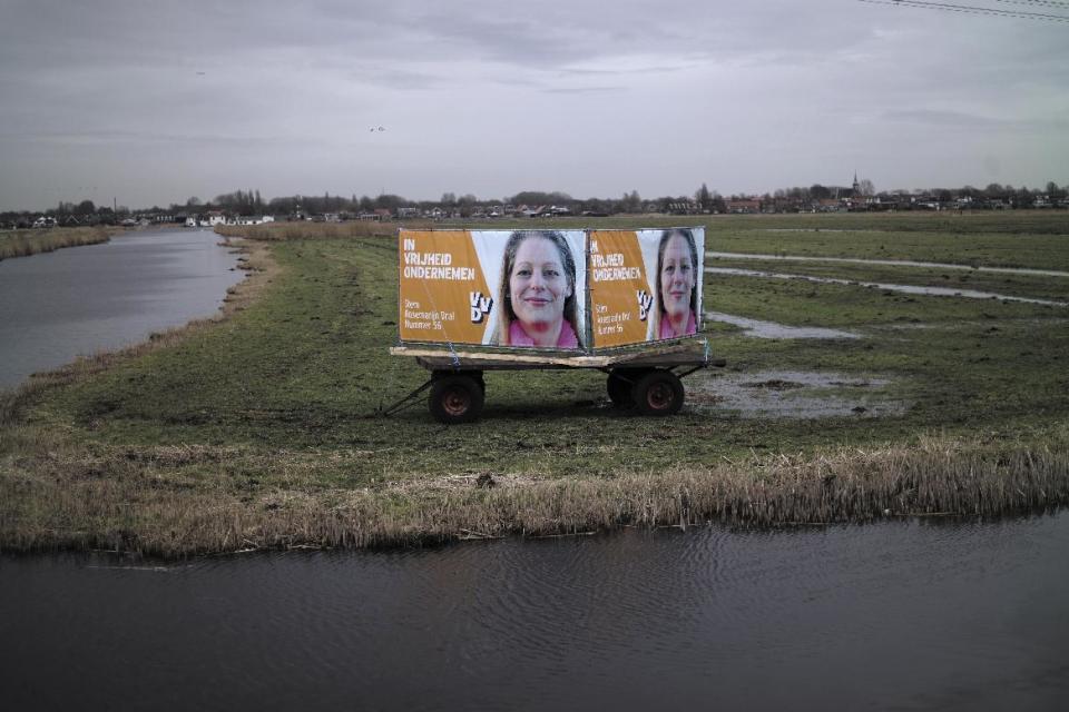 In this Friday, March 3, 2017 photo, an election banner showing Rosemarijn Dral, from the People's Party for Freedom and Democracy, VVD, is displayed in a field in Zaandam, Netherlands. March 15 marks the general election in the Netherlands. (AP Photo/Muhammed Muheisen)