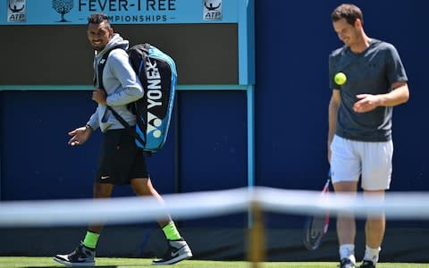 Australia's Nick Kyrgios (L) has a word with Britain's Andy Murray as he practices, ahead of their first round match at the ATP Queen's Club Championships tennis tournament in west London on June 18, 2018. Finally recovered after hip surgery in January, Murray will play his first competitive match for 11 months in the Queen's Club first round next week - Credit: AFP