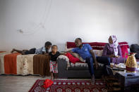 Musa Family, Sudanese migrant sits in their living room at their house in south Tel Aviv, Israel, Friday, Oct. 30, 2020. After Israel and Sudan agreed this month to normalize ties, some 6,000 Sudanese migrants in Israel are again fearing for their fate. Israel has long grappled with how to deal with its tens of thousands of African migrants. (AP Photo/Oded Balilty)