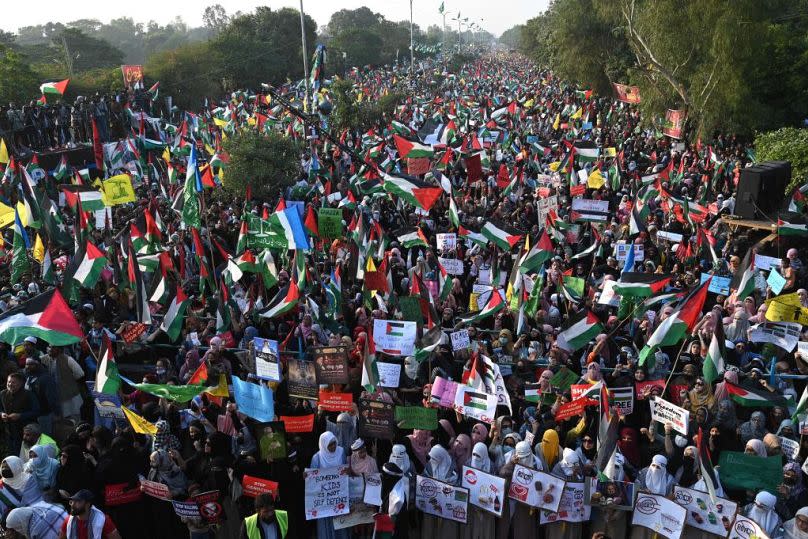 Supporters of right-wing religious Jamaat-e-Islami (JI) party take part in a march to express their solidarity with Palestinians in Lahore on Sunday