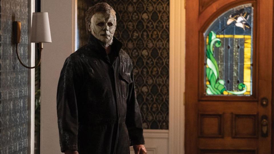 An image from Halloween Ends shows Michael Myers standing in the hallway