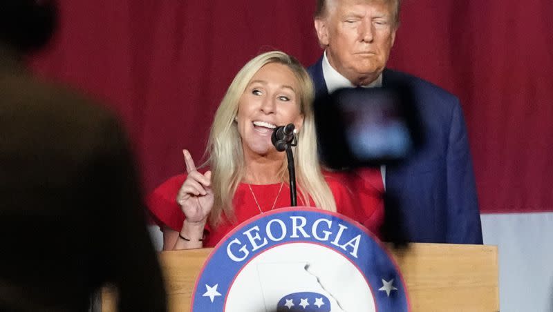 Rep. Marjorie Taylor Greene, R-Ga., speaks as former President Donald Trump looks on at the Georgia Republican convention on June 10, 2023, in Columbus, Ga.