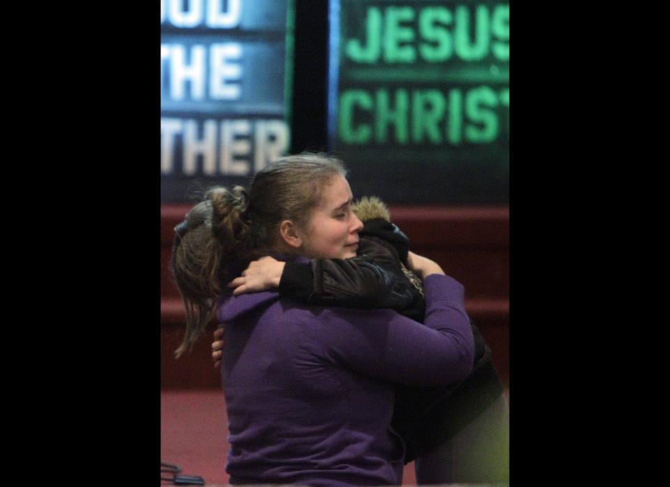 Alissa Sully, 17, hugs a friend before a prayer service for victims of a school shooting at Chardon Assembly of God in Chardon, Ohio Monday, Feb. 27, 2012. A gunman opened fire inside the high school's cafeteria at the start of the school day Monday, killing three students and wounding two others. (AP Photo/Mark Duncan)