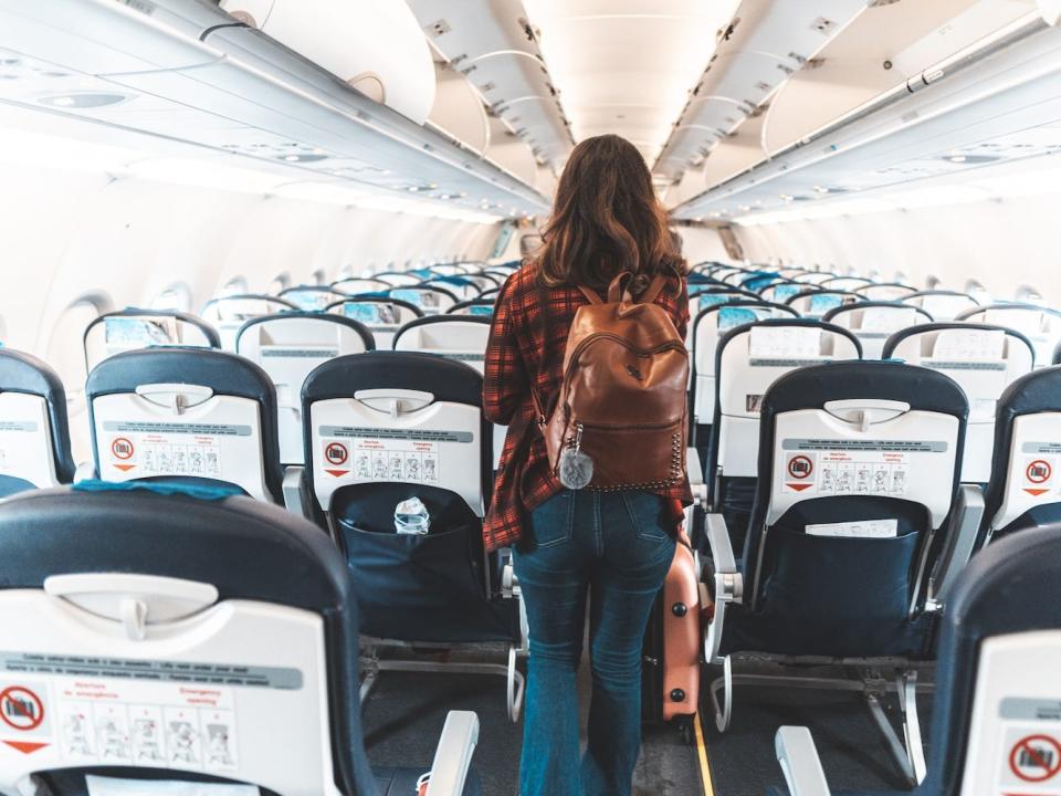 A person boards an airplane.