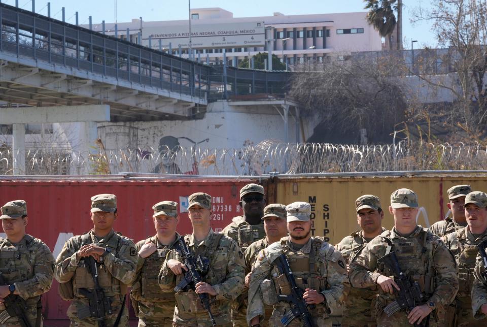 Texas National Guard troops attend a border news conference held by Gov. Greg Abbott and several other GOP state governors Sunday in Eagle Pass.