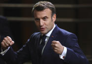 French President Emmanuel Macron speaks with the media as he departs at the end of an EU summit in Brussels, Friday, Feb. 21, 2020. Major contributors to the European Union's budget blocked progress at an emergency summit on Friday, insisting that they would not stump up more funds for the bloc's next long-term spending package. (AP Photo/Olivier Matthys)